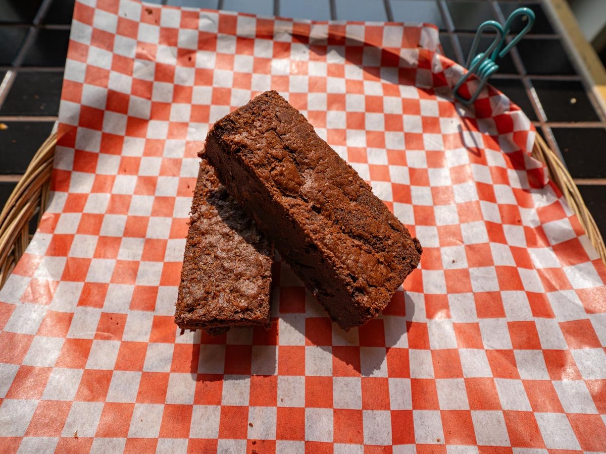 Squares of fudge brownie on red checked paper